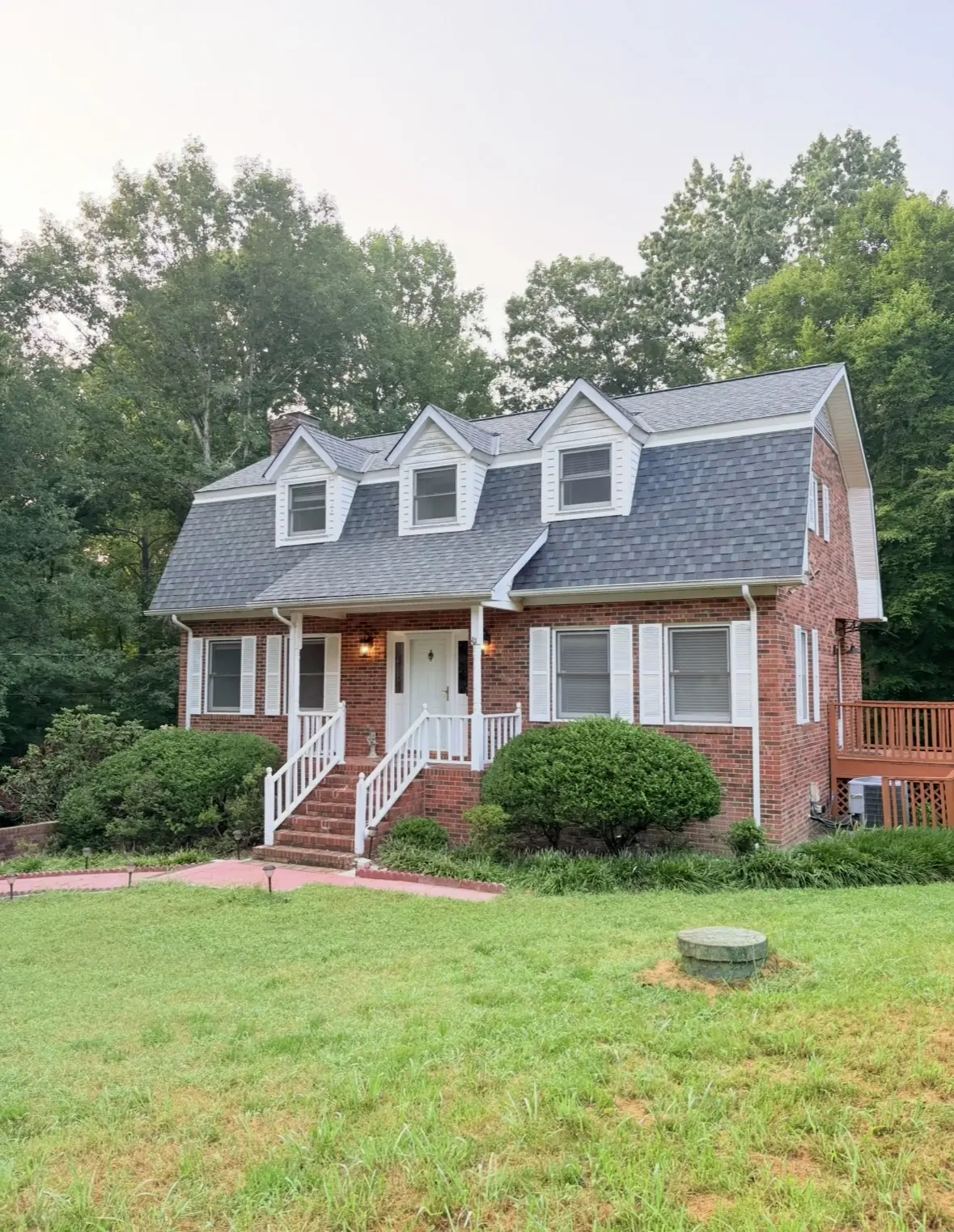 Brick house with a newly shingled roof