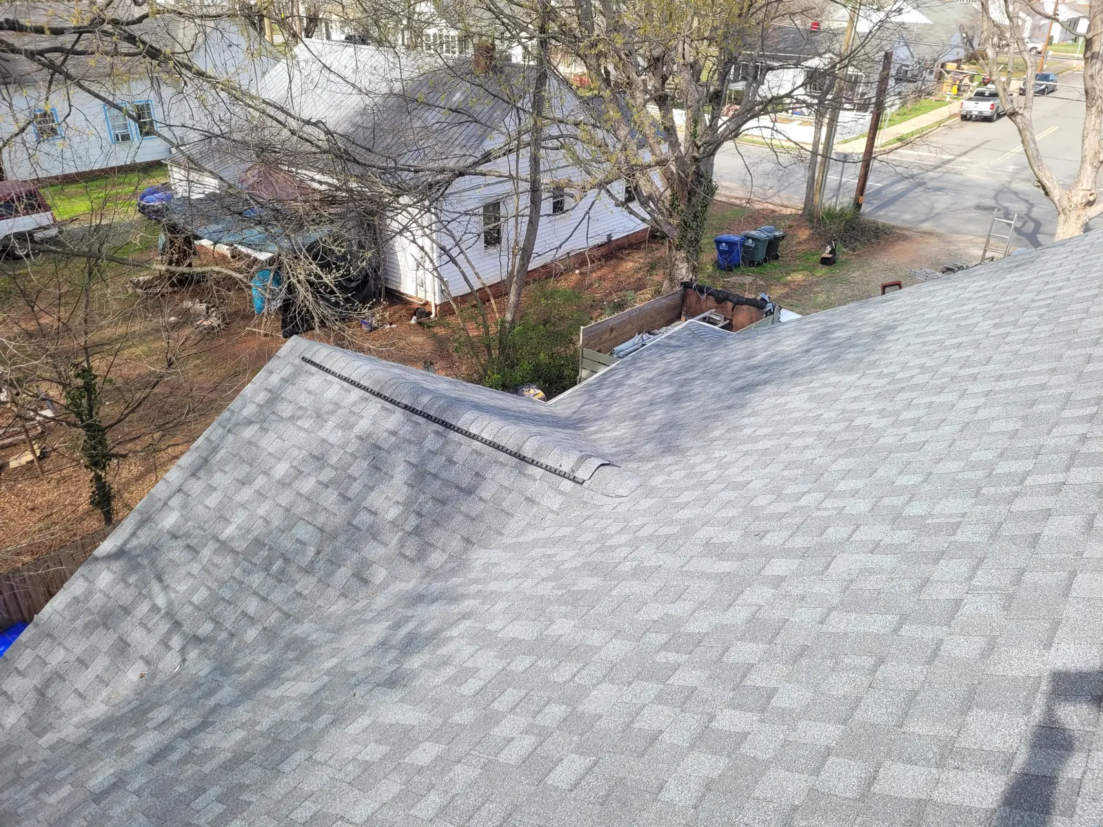 Ridge vent running along the peak of a gray shingle roof